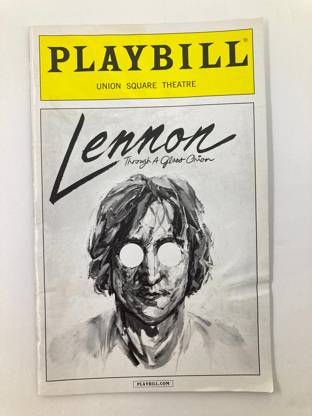 2014 Playbill from Union Square Theatre featuring John Lennon: Through a Glass Onion, showcasing a striking artistic representation of John Lennon.