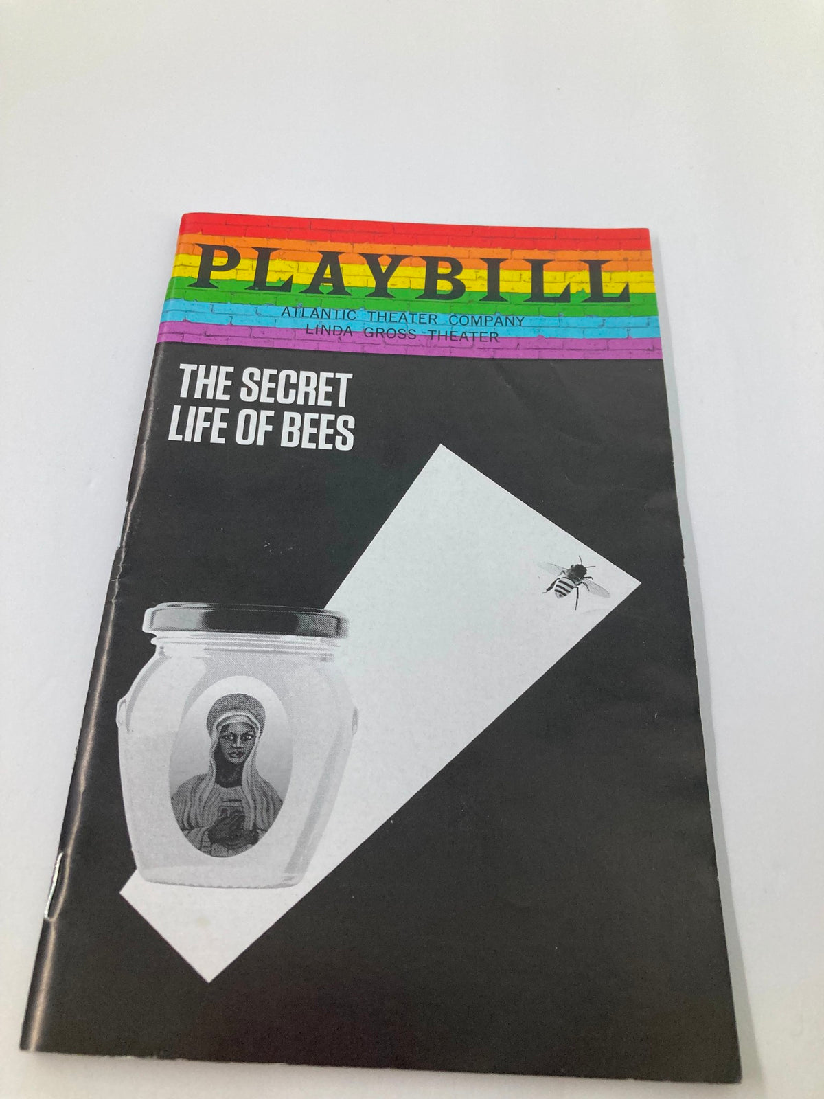 2019 Playbill for The Secret Life of Bees at the Linda Gross Theater featuring a colorful rainbow header and minimalist design.