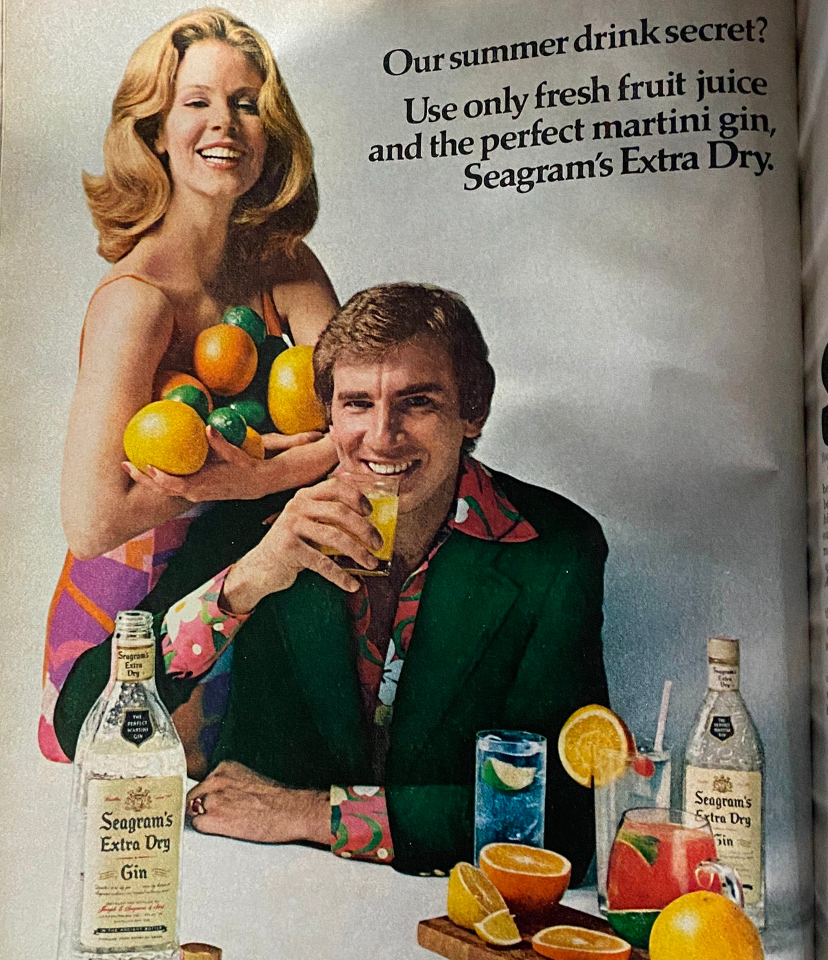 Esquire Magazine August 1973 featuring a summer drink advertisement with a cheerful woman holding fresh fruits and a man enjoying a cocktail, promoting Seagram's Extra Dry gin.