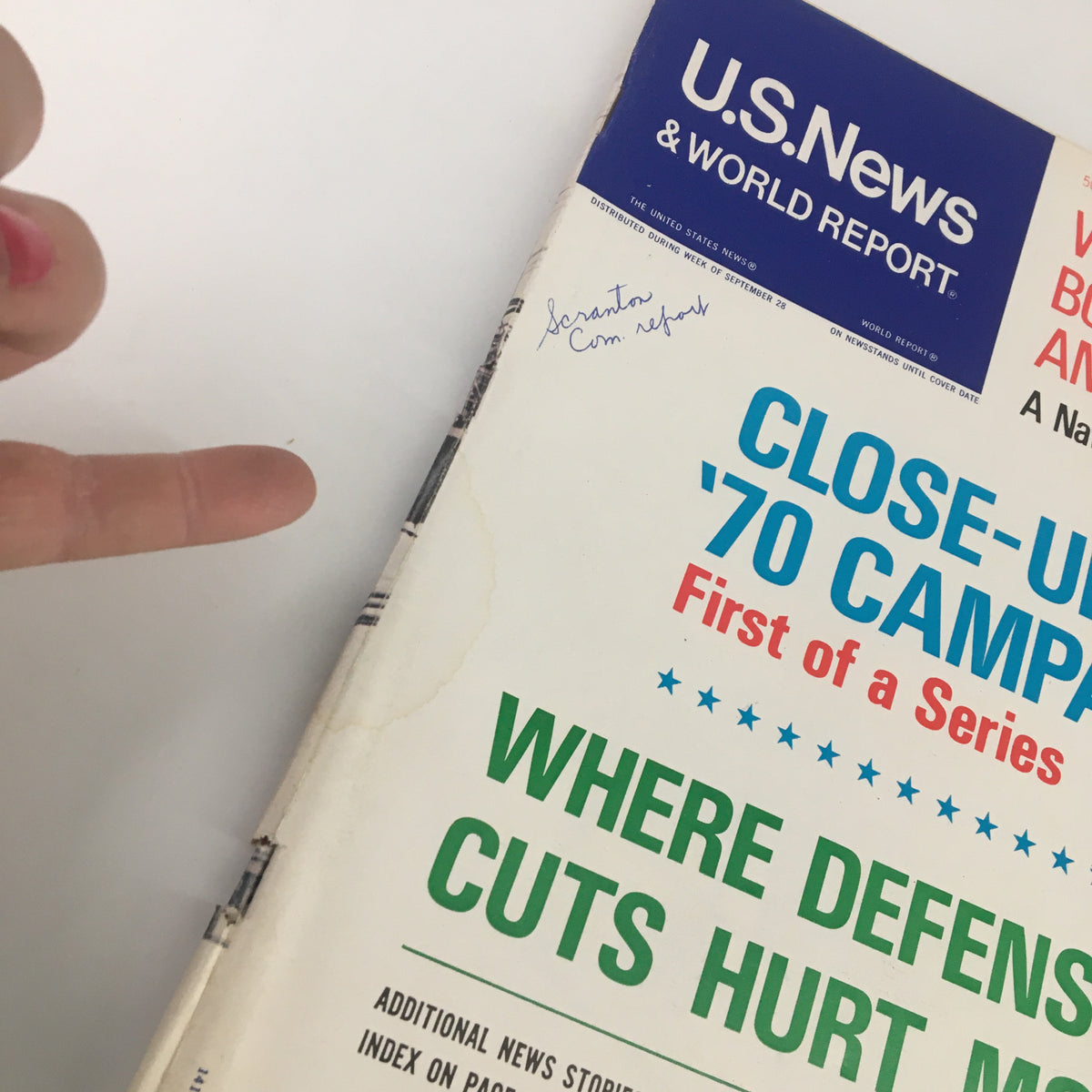 Close-up view of the US News & World Report magazine cover from October 5, 1970, showing the title 'What's Bothering Americans.' A hand points to the magazine, emphasizing the details.