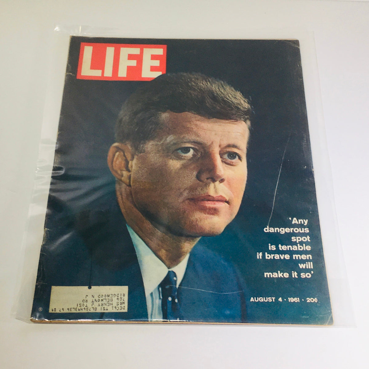 Life Magazine cover from August 4, 1961 featuring President John F. Kennedy with the quote 'Any Dangerous Spot is Tenable'. The magazine is displayed in a protective plastic covering, showcasing a close-up of Kennedy's face.