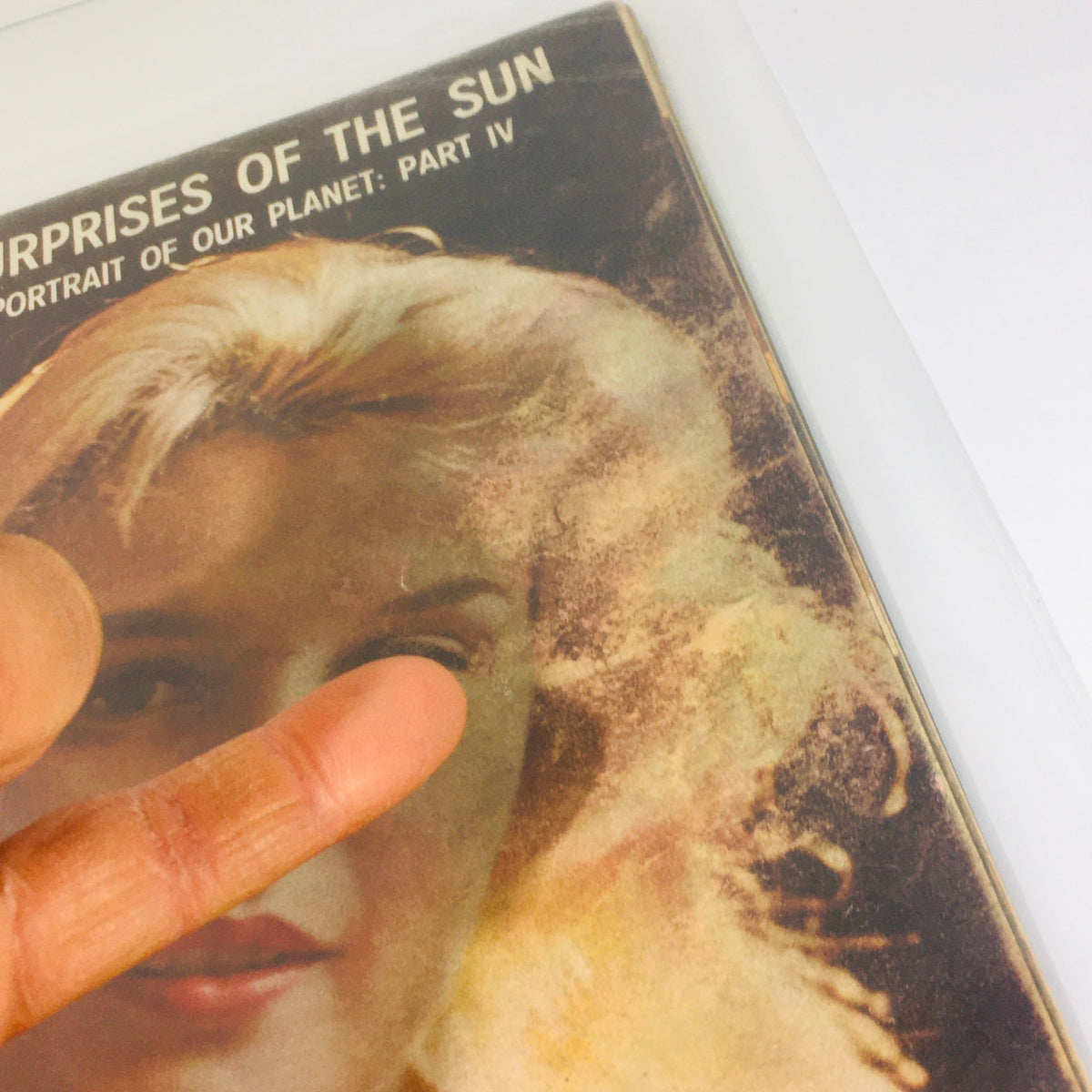 Close-up of the Vintage Life Magazine cover from November 28, 1960, highlighting Carroll Baker in 'Baby Doll Grows Up' with finger pointing at details, illustrating its vintage condition.