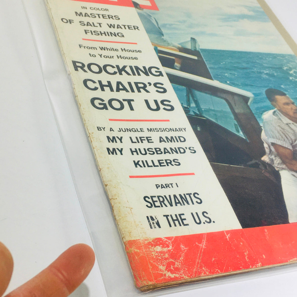 Close-up view of Vintage Life Magazine April 7 1961 cover highlighting Masters of Salt Water Fishing and Rocking Chair's Got Us with wear showing its age.