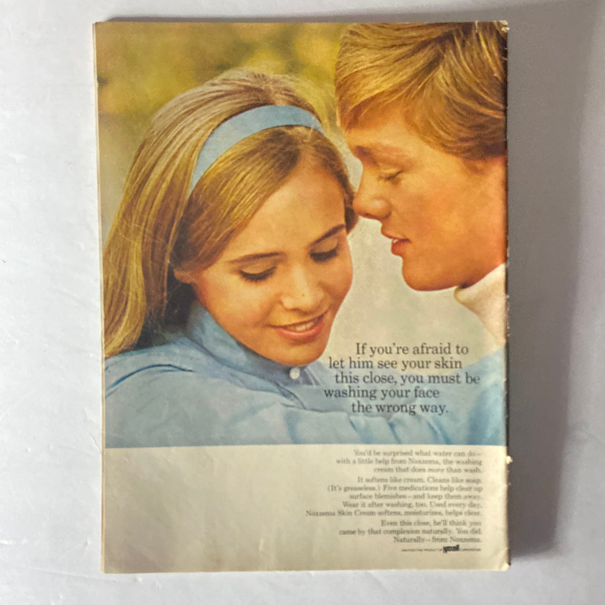 Back cover of American Girl Magazine March 1969, featuring a romantic image of a couple closely looking at each other, promoting Noxzema Skin Cream with a slogan about skin care.