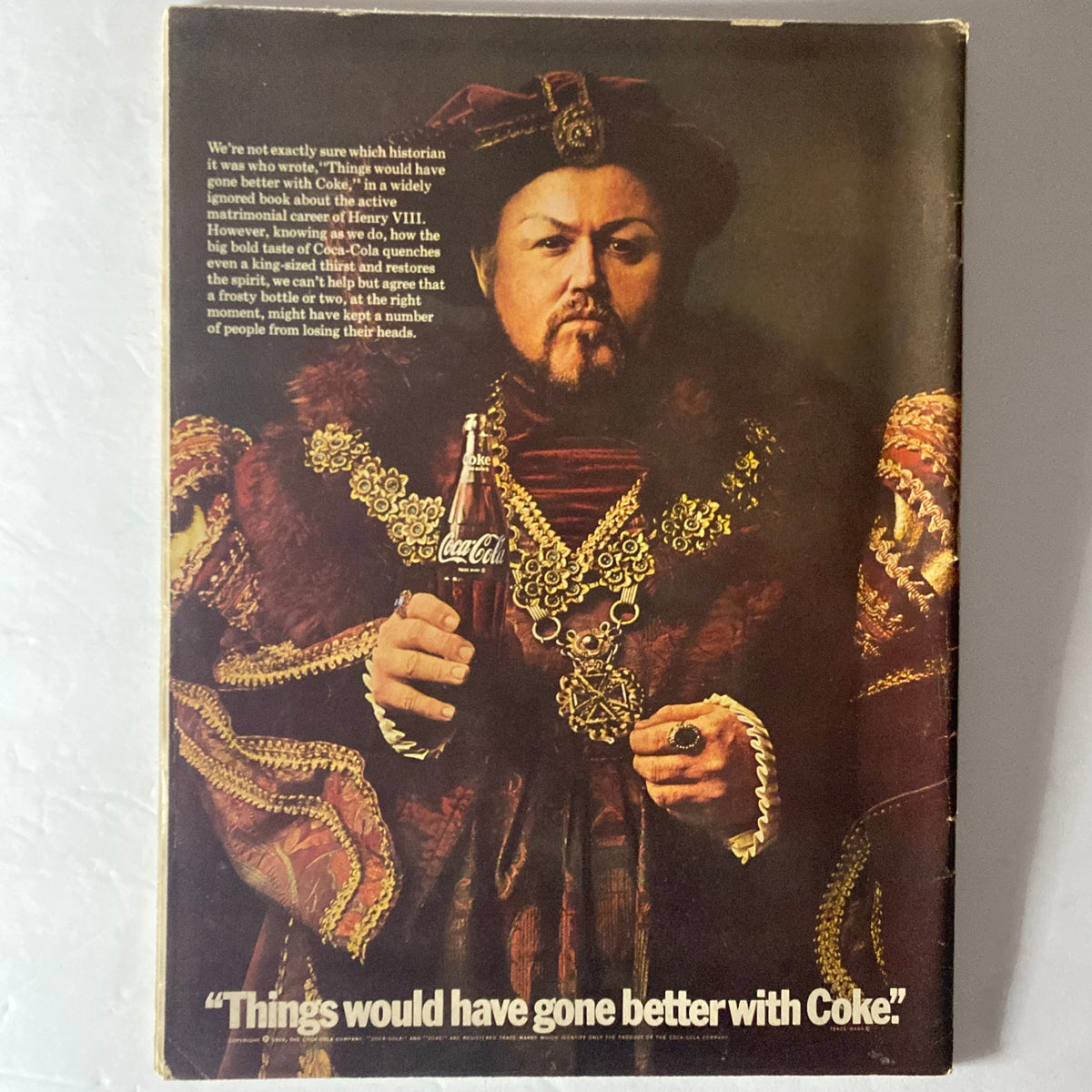 Back cover of American Girl Magazine April 1969 titled 'A Girl and Her Money', featuring a historical figure holding a Coca-Cola bottle with the caption 'Things would have gone better with Coke'.