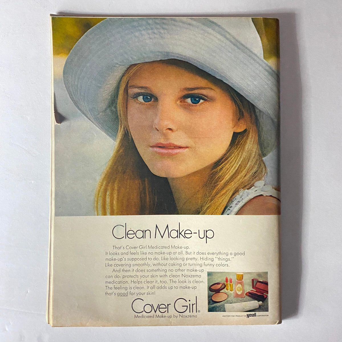 Advertisement for Cover Girl Medicinal Make-up featured in Teen Magazine May 1969, showcasing a woman in a wide-brimmed hat.