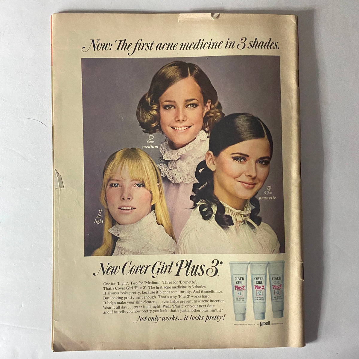 Back cover of American Girl Magazine December 1968 featuring an advertisement for Cover Girl Plus 3 acne medicine with three models displaying different shades.