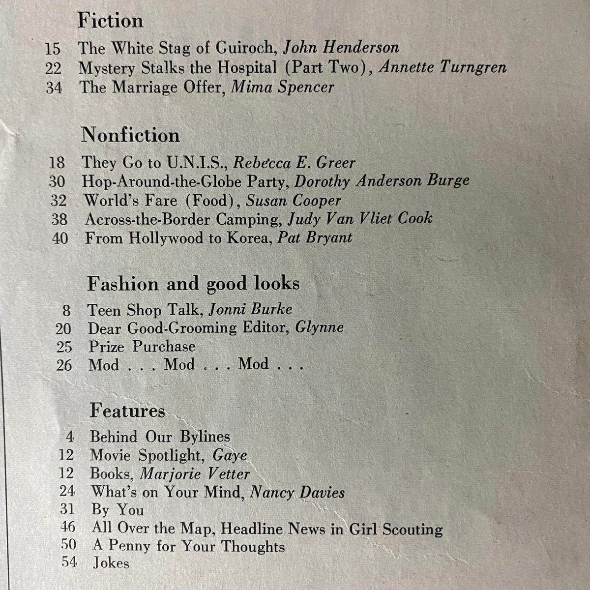 Table of contents for American Girl Magazine February 1965, listing featured fiction and nonfiction stories including 'The White Stag of Guiroch' by John Henderson and articles like 'They Go to U.N.I.S.' by Rebecca E. Greer.