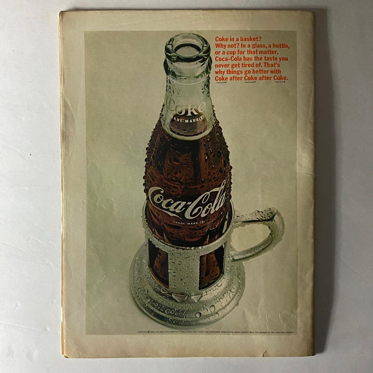 American Girl Magazine July 1966 back cover showcasing a vintage Coca-Cola advertisement, featuring a glass bottle with condensation and a humorous tagline.
