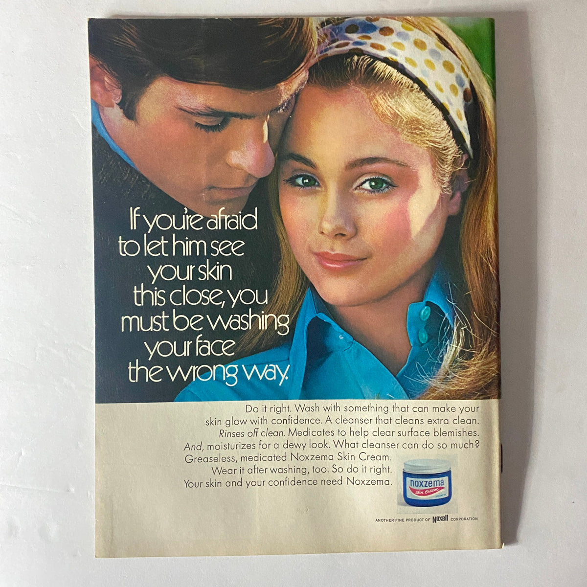 Back cover of American Girl Magazine November 1969 featuring an advertisement for Noxzema skin cream with a young couple, illustrating beauty and skincare trends of the 1960s.