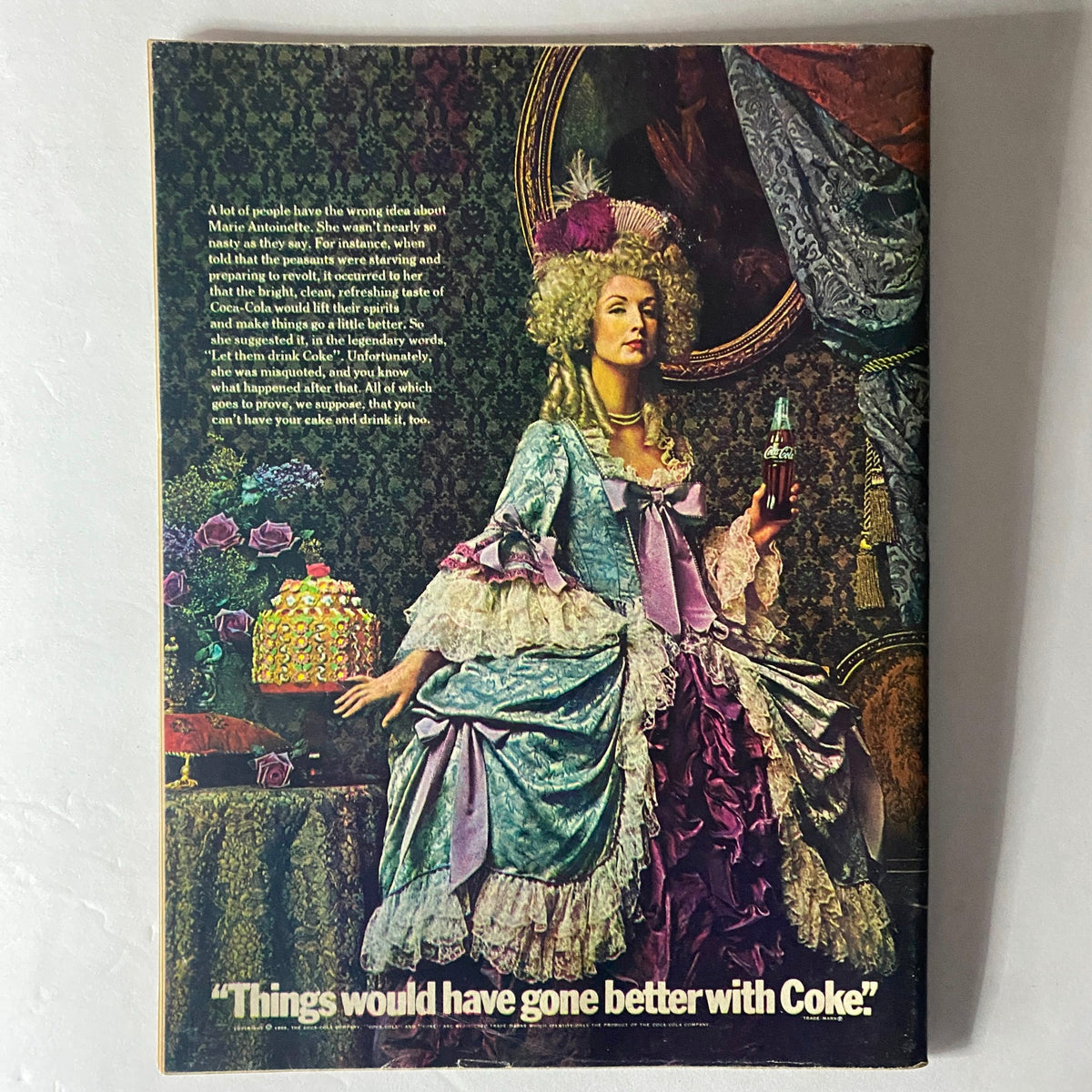 Back cover of a magazine featuring a historical themed advertisement with a woman in a lavish dress holding a Coca Cola, captioned 'Things would have gone better with Coke' showcasing vintage marketing.