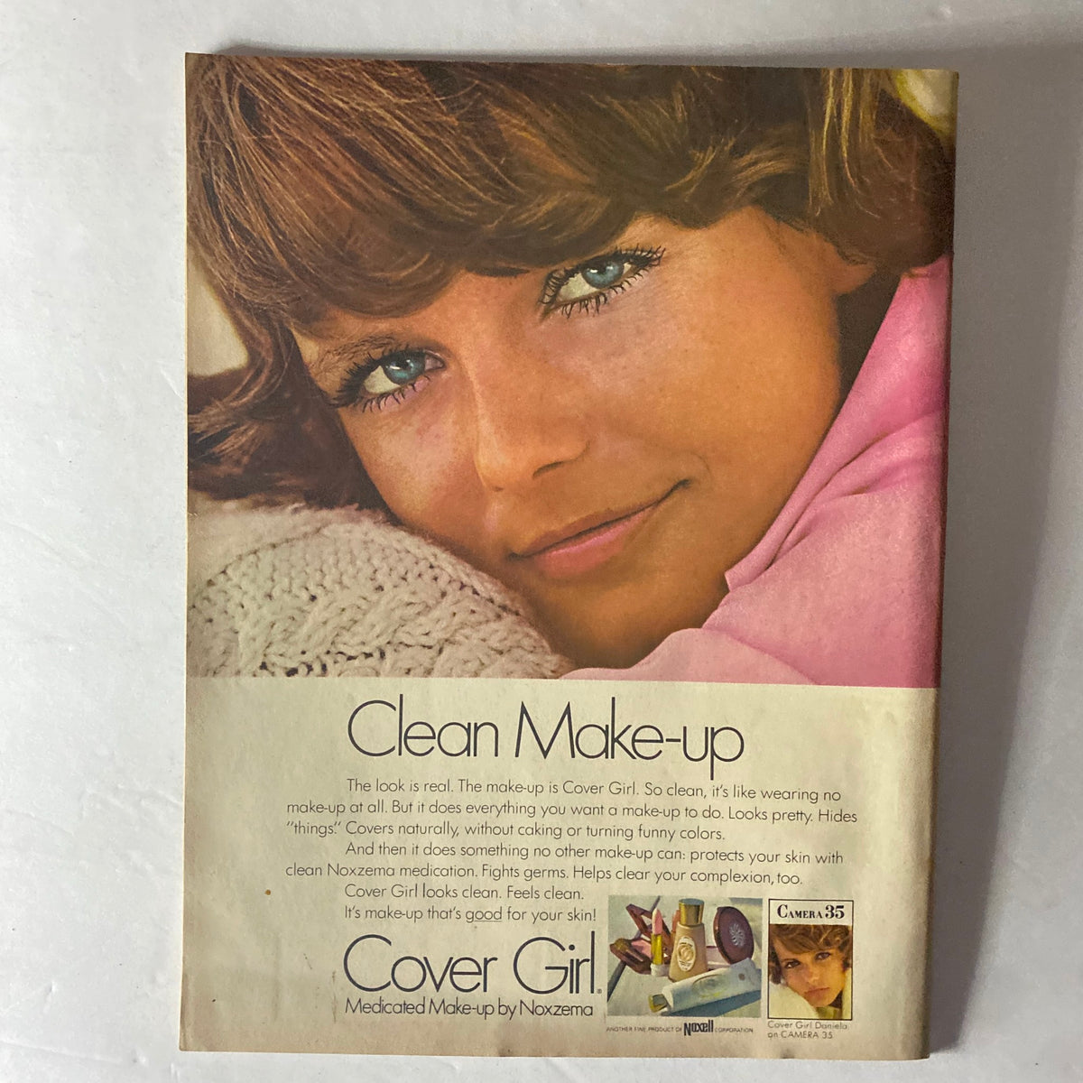 Vintage advertisement for Cover Girl makeup from the February 1970 American Girl Magazine, showcasing a model with natural makeup and the tagline 'Clean Make-up'.