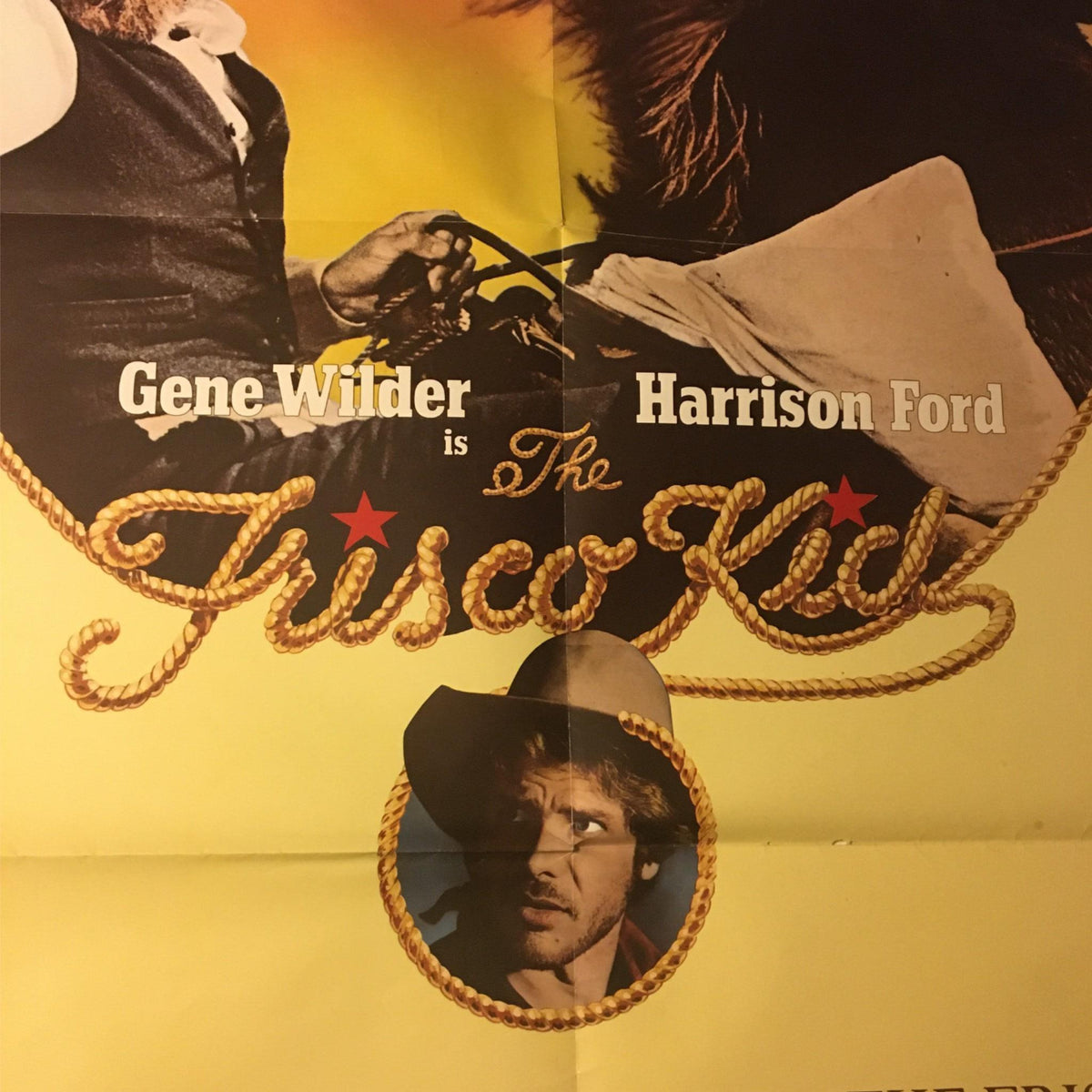 Close-up view of the 1979 The Frisco Kid Original Movie Poster featuring Gene Wilder and Harrison Ford. The design includes the film title in decorative font, emphasizing its Western theme.