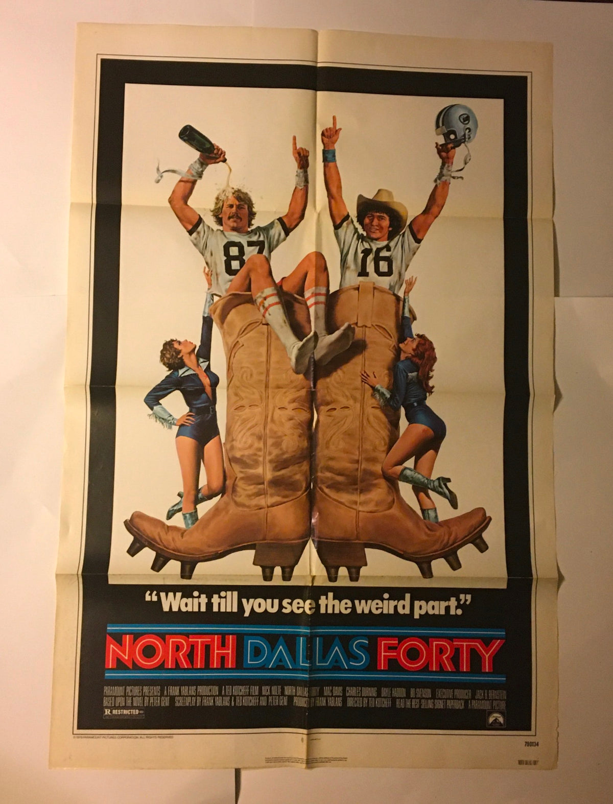 1979 North Dallas Forty original movie poster showcasing Nick Nolte and Mac Davis celebrating with oversized cowboy boots. The catchphrase 'Wait till you see the weird part' is displayed prominently.