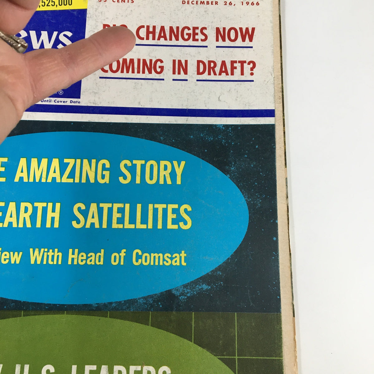 Another angle of the US News & World Report Magazine cover from December 26, 1966, showing 'The Amazing Story of Earth Satellites' and the question about draft changes.