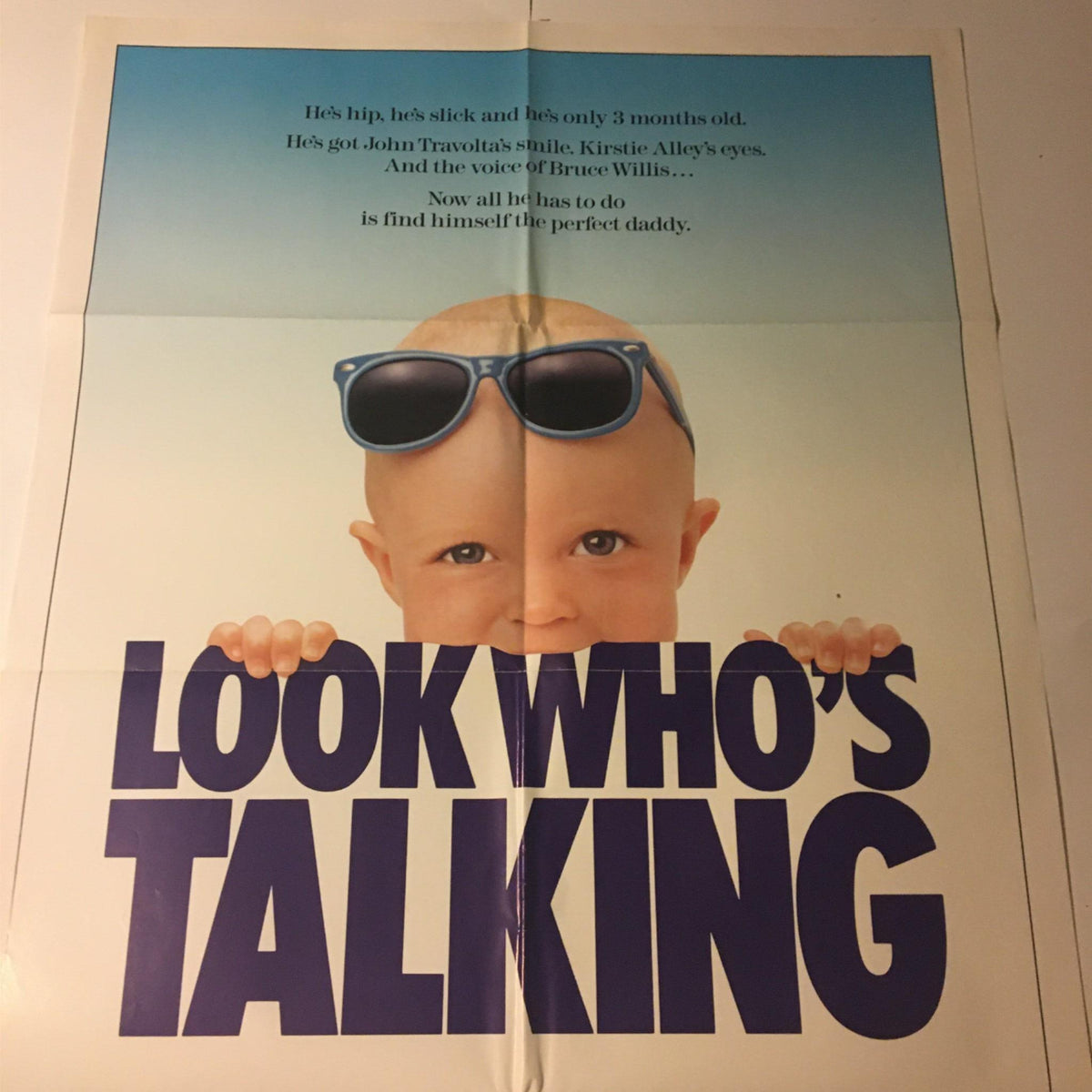 1989 Look Who's Talking 41" x 27" Original Movie Poster with John Travolta, depicting an adorable infant with sunglasses behind bold text, capturing the film's lighthearted spirit.