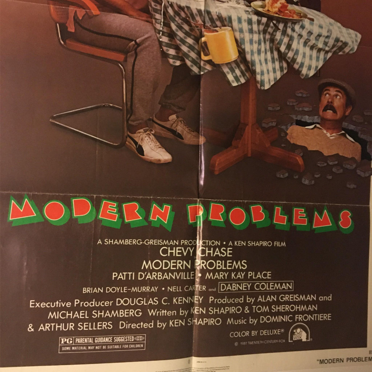 Bottom section of the 1981 Modern Problems movie poster showing the title and comedic scene with Chevy Chase.