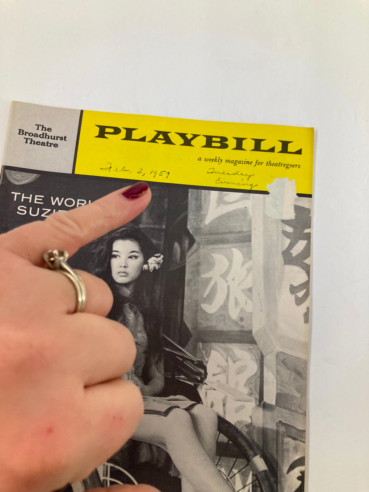 Close-up of the 1959 Playbill for The World of Suzie Wong, with a handwritten date and signature, highlighting the historical significance of the Broadhurst Theatre production.