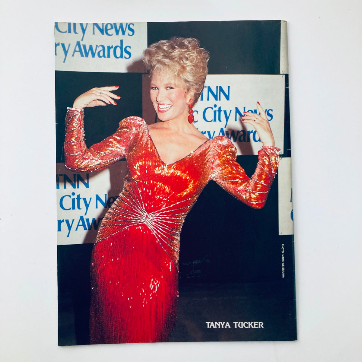 Colorful promotional image of Tanya Tucker at an event, accompanying the Country Song Roundup Magazine December 1991, emphasizing her role in the country music genre.