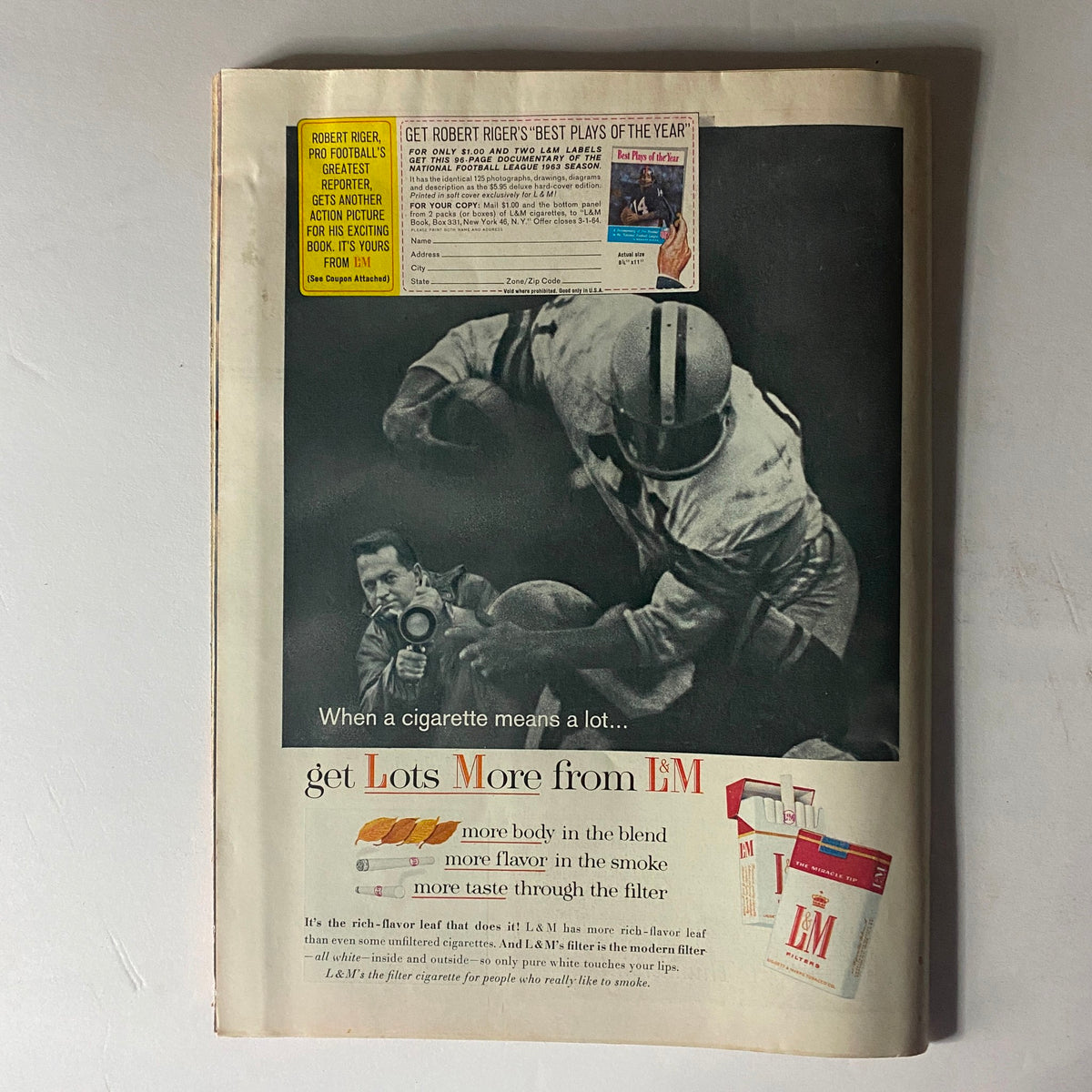 Time Magazine January 10, 1964, Vol 82 No. 2 featuring an advertisement for L&M cigarettes with a dramatic black-and-white image of a football player and a photographer, capturing the essence of mid-20th-century advertising.