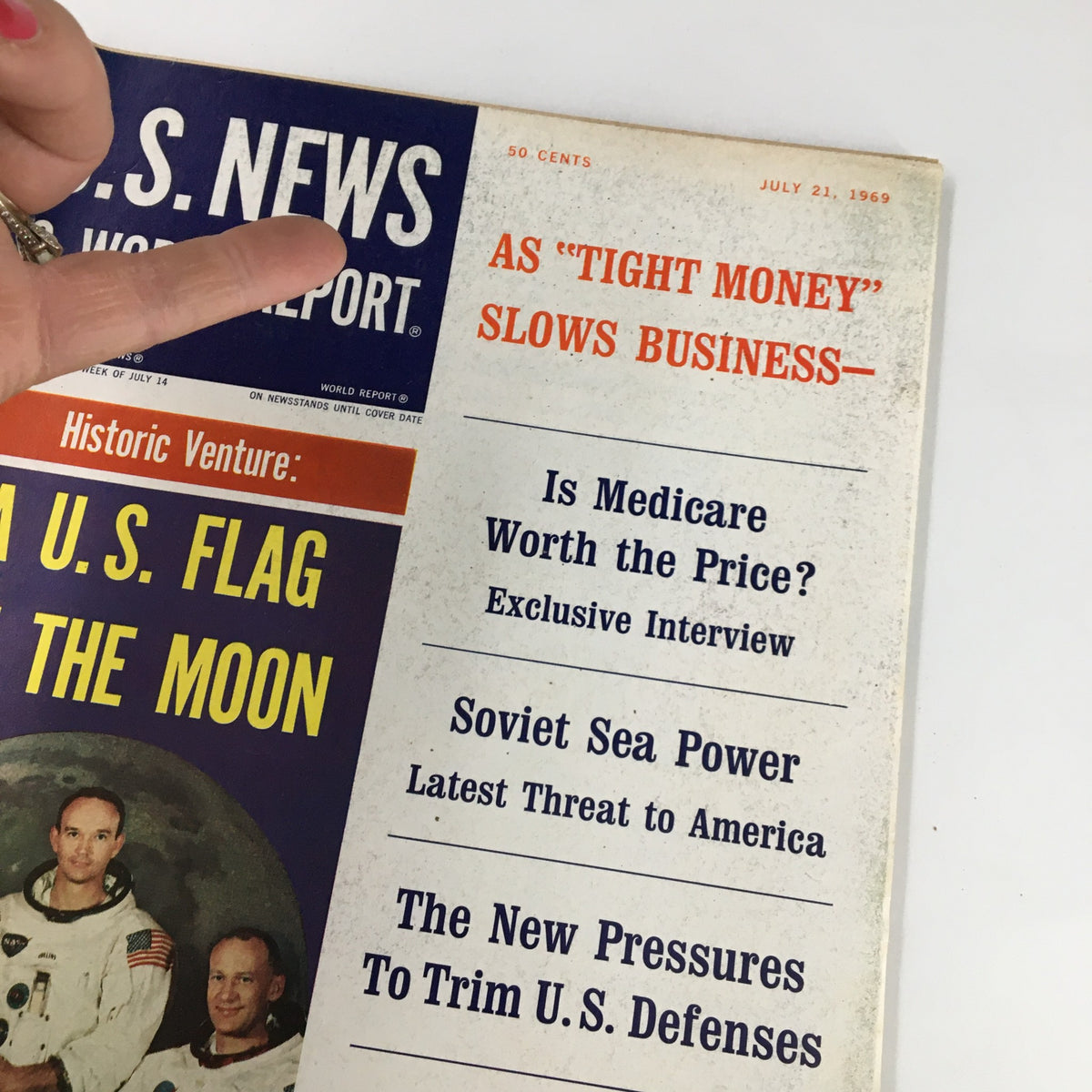 Close-up of the cover of US News & World Report Magazine July 21, 1969, highlighting the section 'As Tight Money Slows Business' and featuring content about space exploration and historical events.