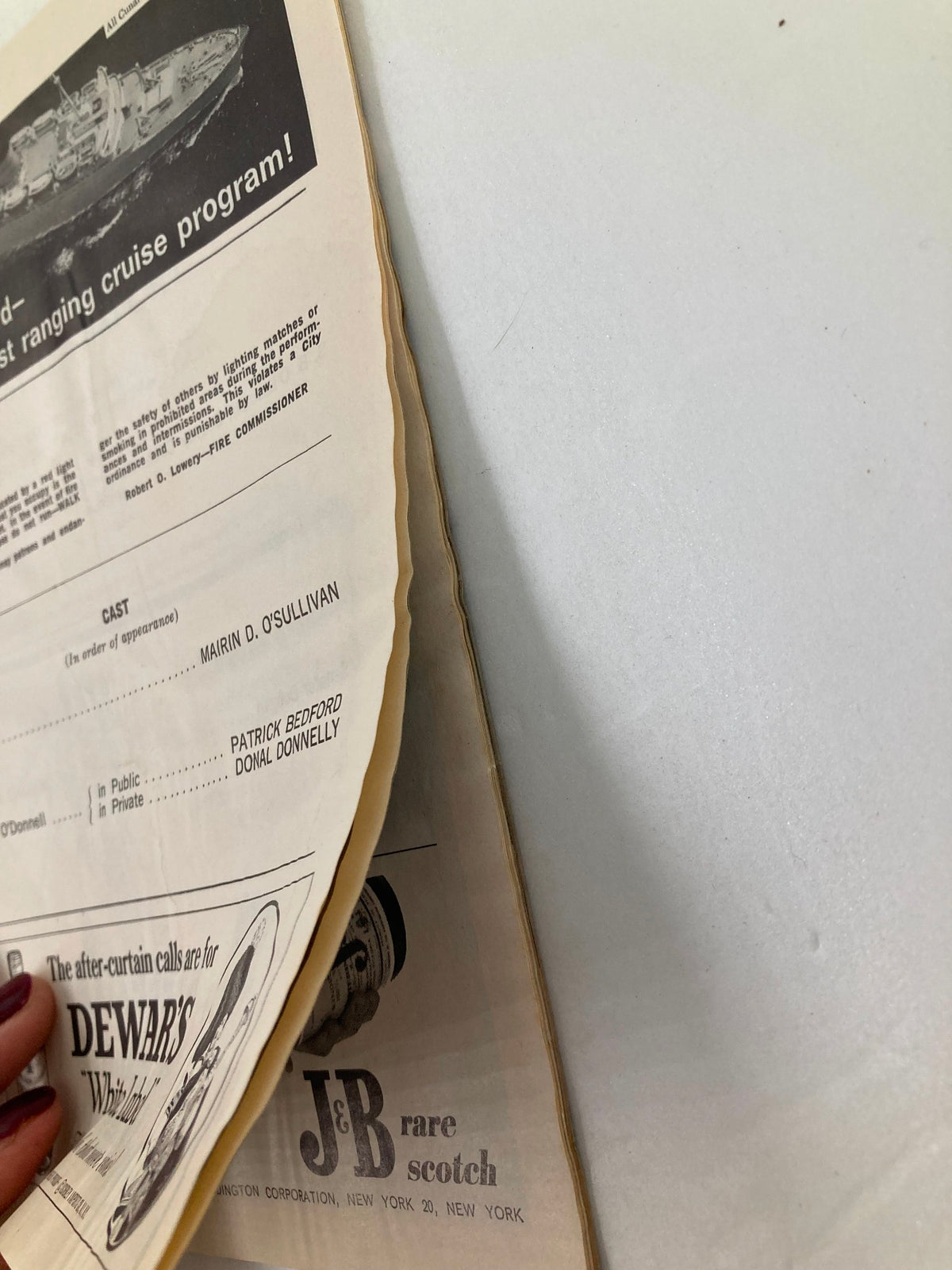 Edge view of the 1966 Playbill for The Plymouth Theatre, displaying the aged paper and vintage advertising for Dewar's whiskey alongside cast information from 'Philadelphia, Here I Come!'.