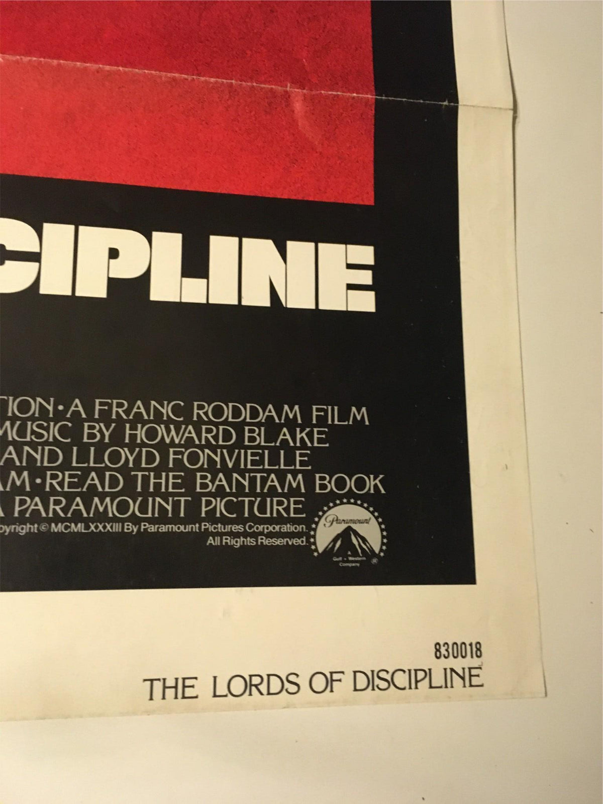 Bottom detail of the 1983 The Lords of Discipline Original Movie Poster, displaying credits and a Paramount Pictures logo. A valuable piece for film memorabilia collectors.