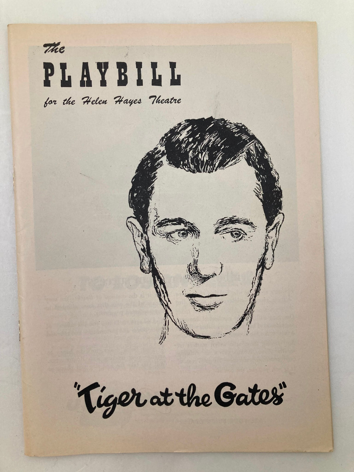 1956 Playbill for 'Tiger at the Gates' showcasing the iconic production at the Helen Hayes Theatre with a sketched portrait of a male actor on the cover.
