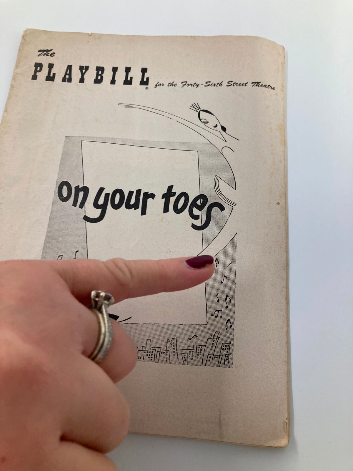 Cover of the 1954 Playbill for the 46th Street Theatre featuring the title 'On Your Toes' and an elegant design.