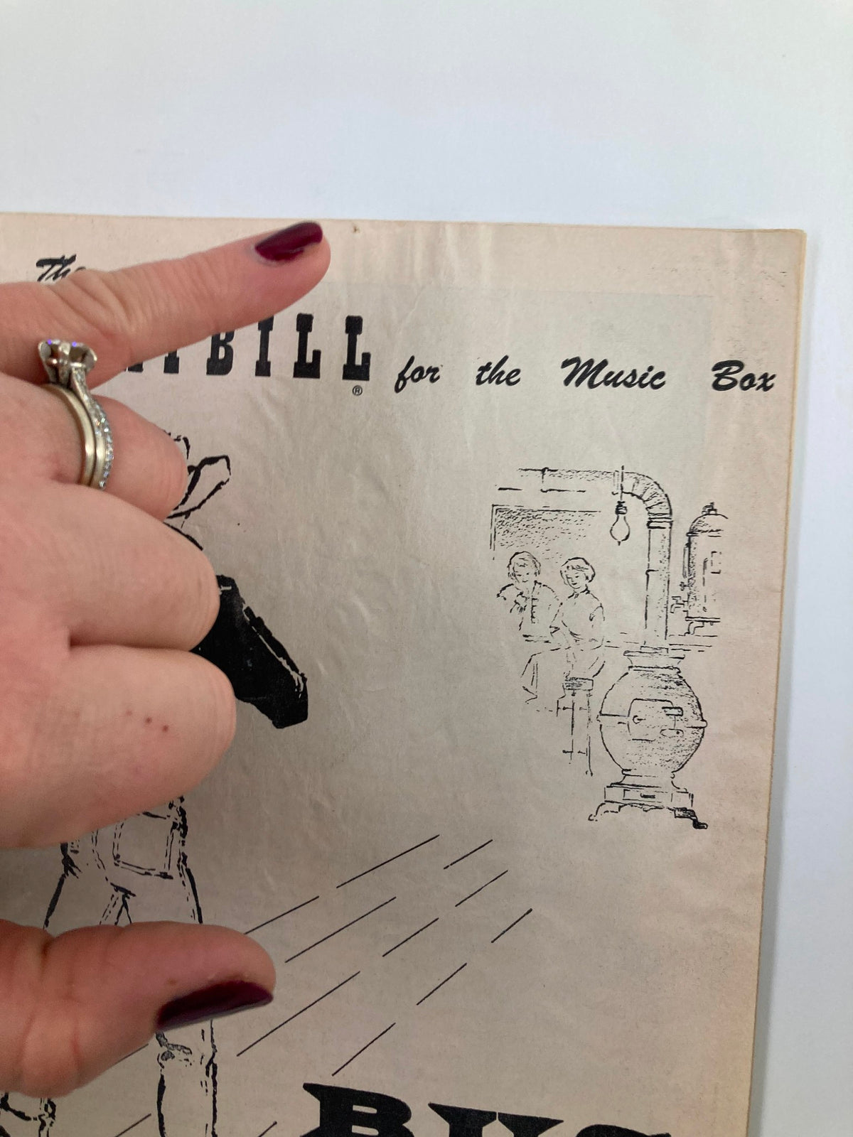 Close-up of the top portion of a 1955 Playbill for The Music Box featuring the title 'Bus Stop' with a hand pointing at it, showcasing the vintage design.
