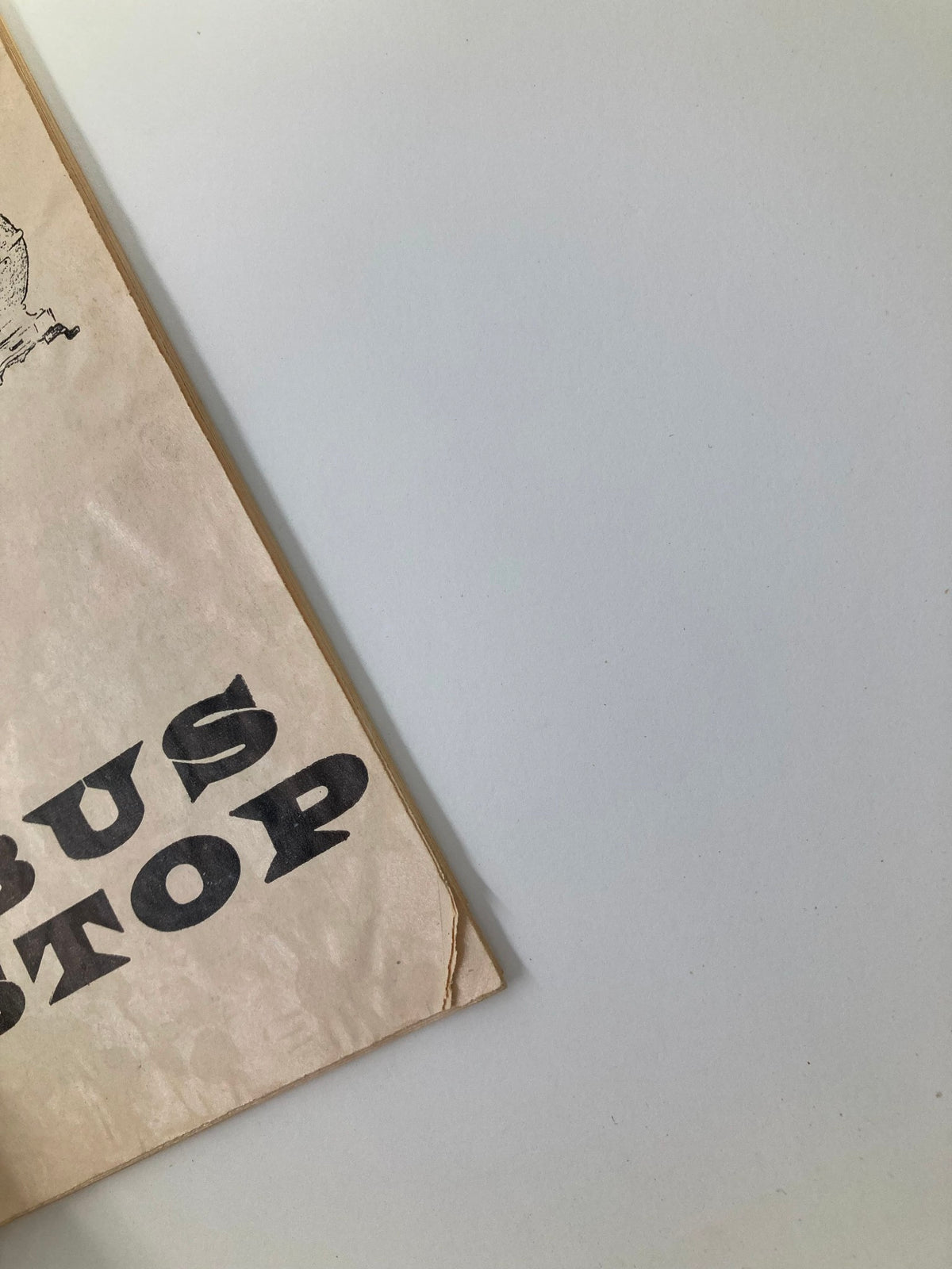 Side view of the 1955 Playbill for 'Bus Stop' at The Music Box, highlighting the title and showing signs of wear indicating its vintage condition.