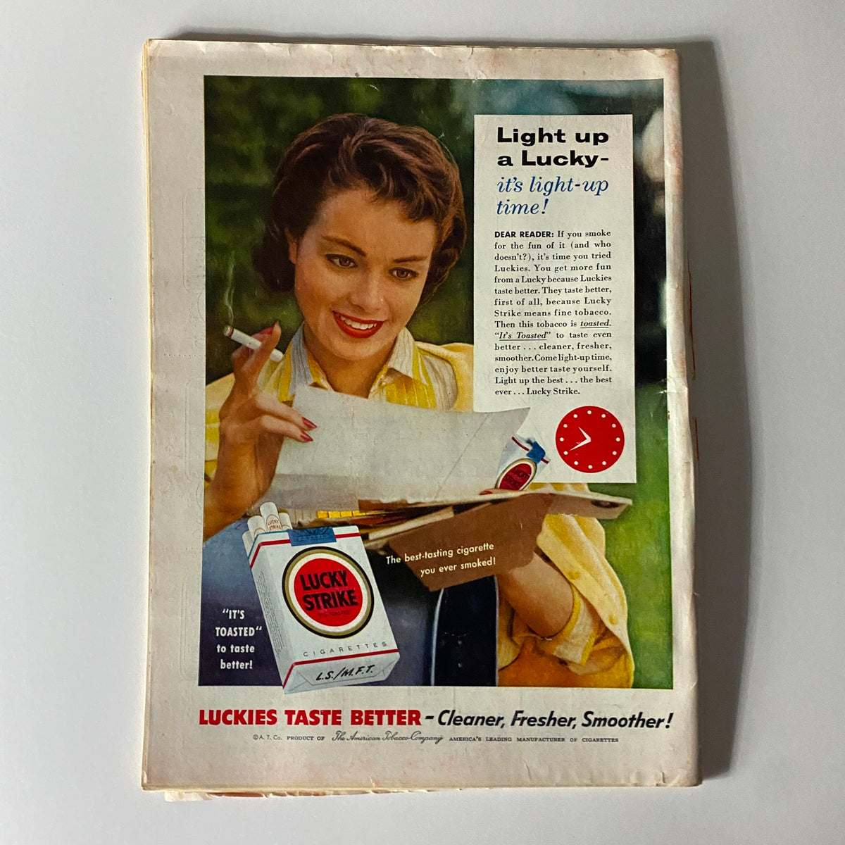 Back cover advertisement of Time Magazine August 22, 1955, Vol 66 No. 8 featuring a vintage Lucky Strike cigarette ad, showcasing a woman lighting a cigarette and promoting Lucky Strike cigarettes.