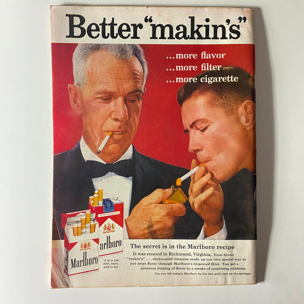 Vintage advertisement page highlighting Marlboro cigarettes with the tagline 'Better makin's' showcasing two men sharing a light, with cigarette packaging displayed prominently.