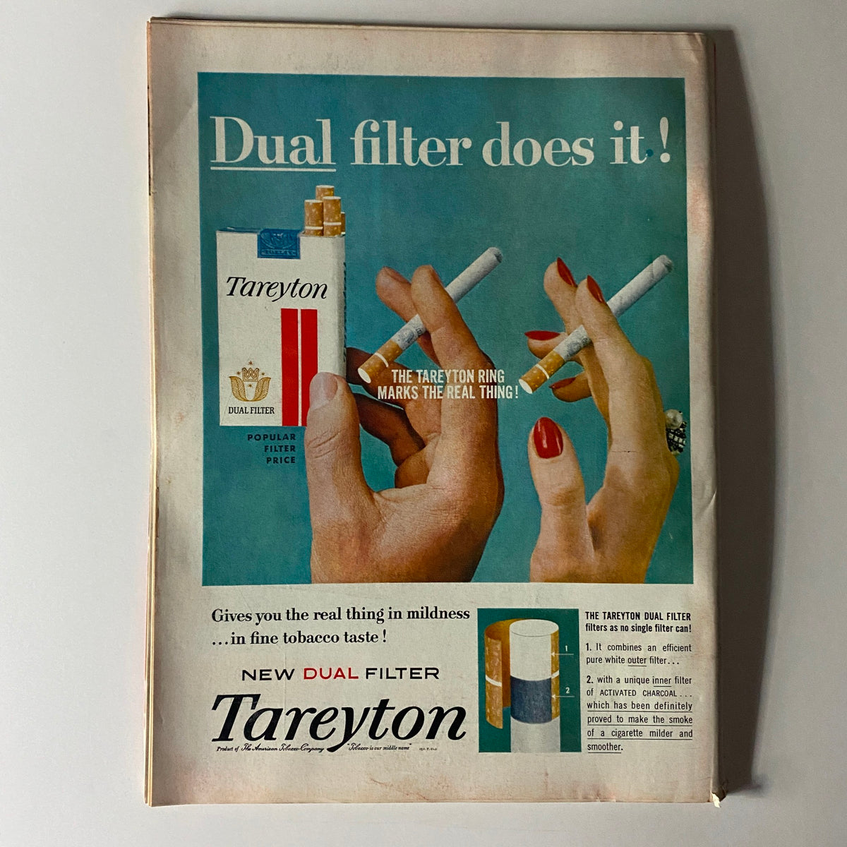 Vintage advertisement for Tareyton cigarettes displayed in a Time Magazine, showcasing two hands holding cigarettes and emphasizing the 'Dual Filter' feature.