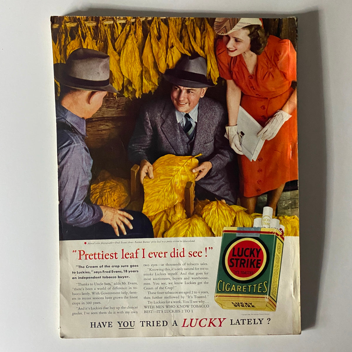 Vintage advertisement from Mademoiselle Magazine July 1940, featuring Lucky Strike cigarettes with people discussing tobacco leaves.