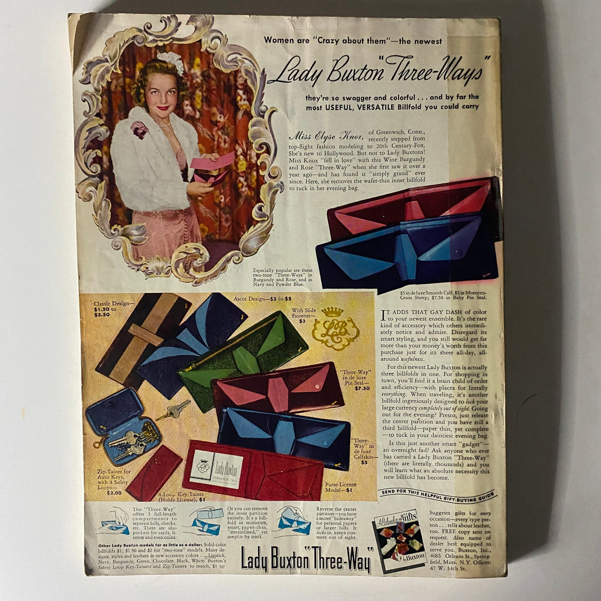 Mademoiselle Magazine October 1940 - Advertisement for Lady Buxton 'Three-Ways', featuring a fashionable model and a colorful display of versatile billfolds, illustrating 1940s style accessories.