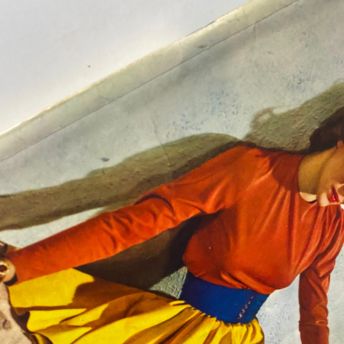 Close-up of a woman wearing a red top and yellow skirt, featured in Mademoiselle Magazine January 1940, showcasing the fashion trends of the era.