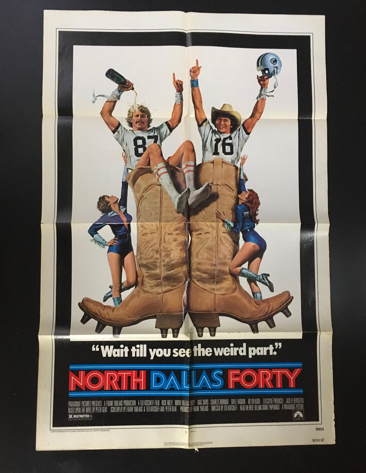 1979 North Dallas Forty original movie poster featuring Nick Nolte and Mac Davis with a humorous depiction of football players. Bold text reads 'Wait till you see the weird part.' The poster features iconic imagery from the film.