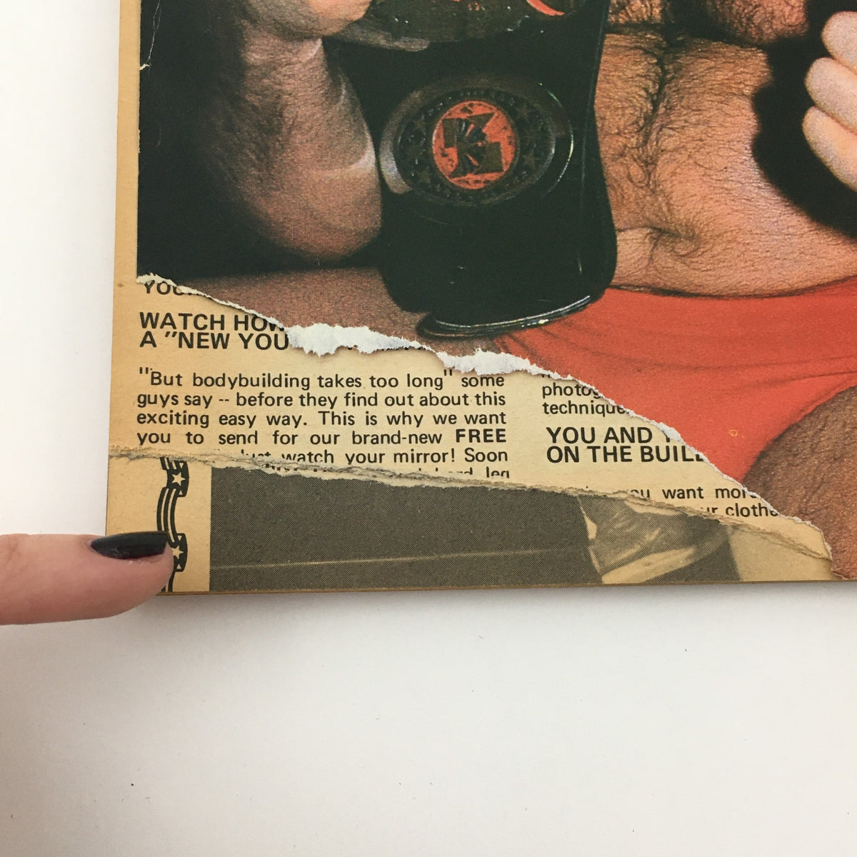 Close-up of the champion wrestler in Wrestling Scene Magazine July 1985 Issue #23. The image shows part of an advertisement in the magazine's corner, adding vintage appeal.