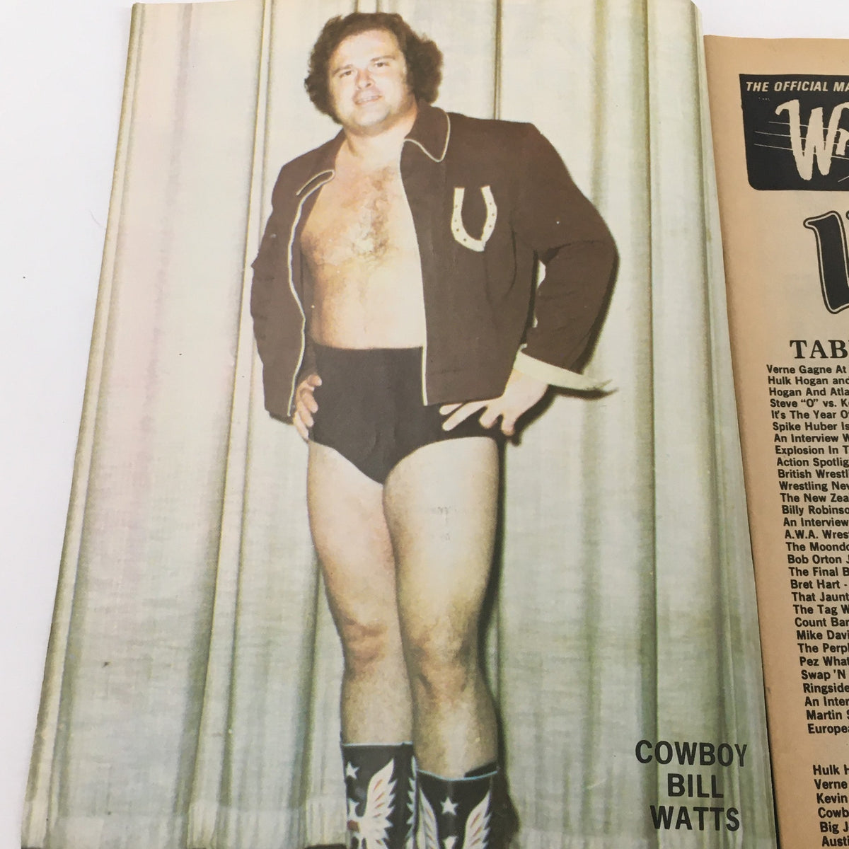 Cowboy Bill Watts posing for Wrestling Magazine #71, 1981, dressed in wrestling attire and a jacket, standing confidently with a backdrop.