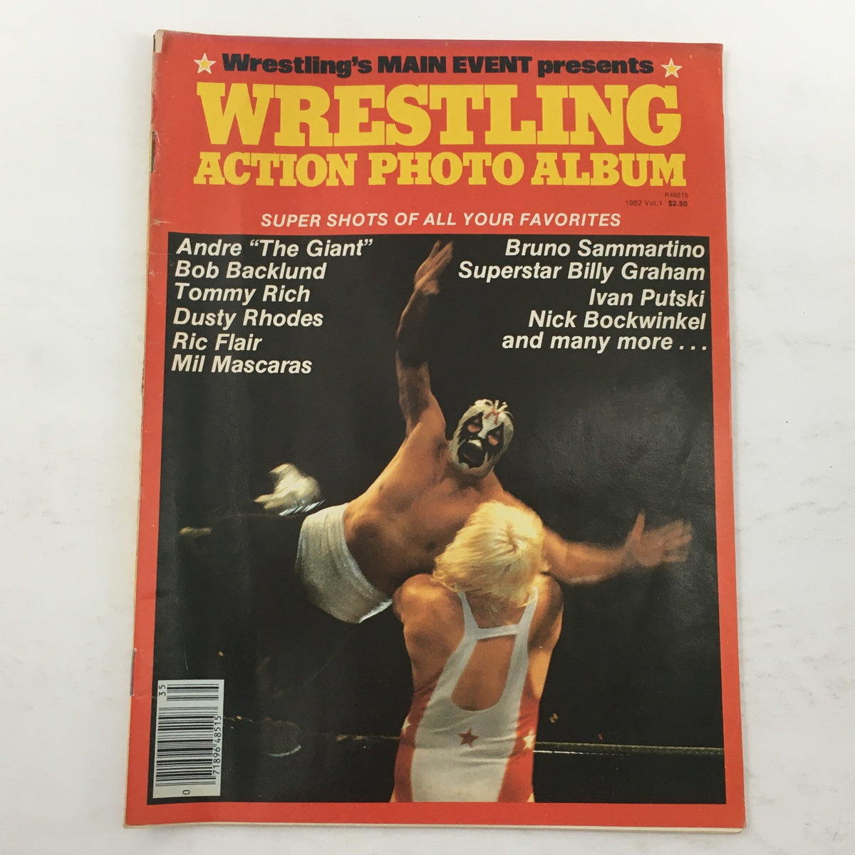 Wrestling Action Photo Album 1982 Vol 1 featuring the cover with Andre The Giant and Bruno Sammartino along with other wrestling stars like Bob Backlund and Tommy Rich. The vibrant red and yellow design highlights iconic performers from the wrestling world.