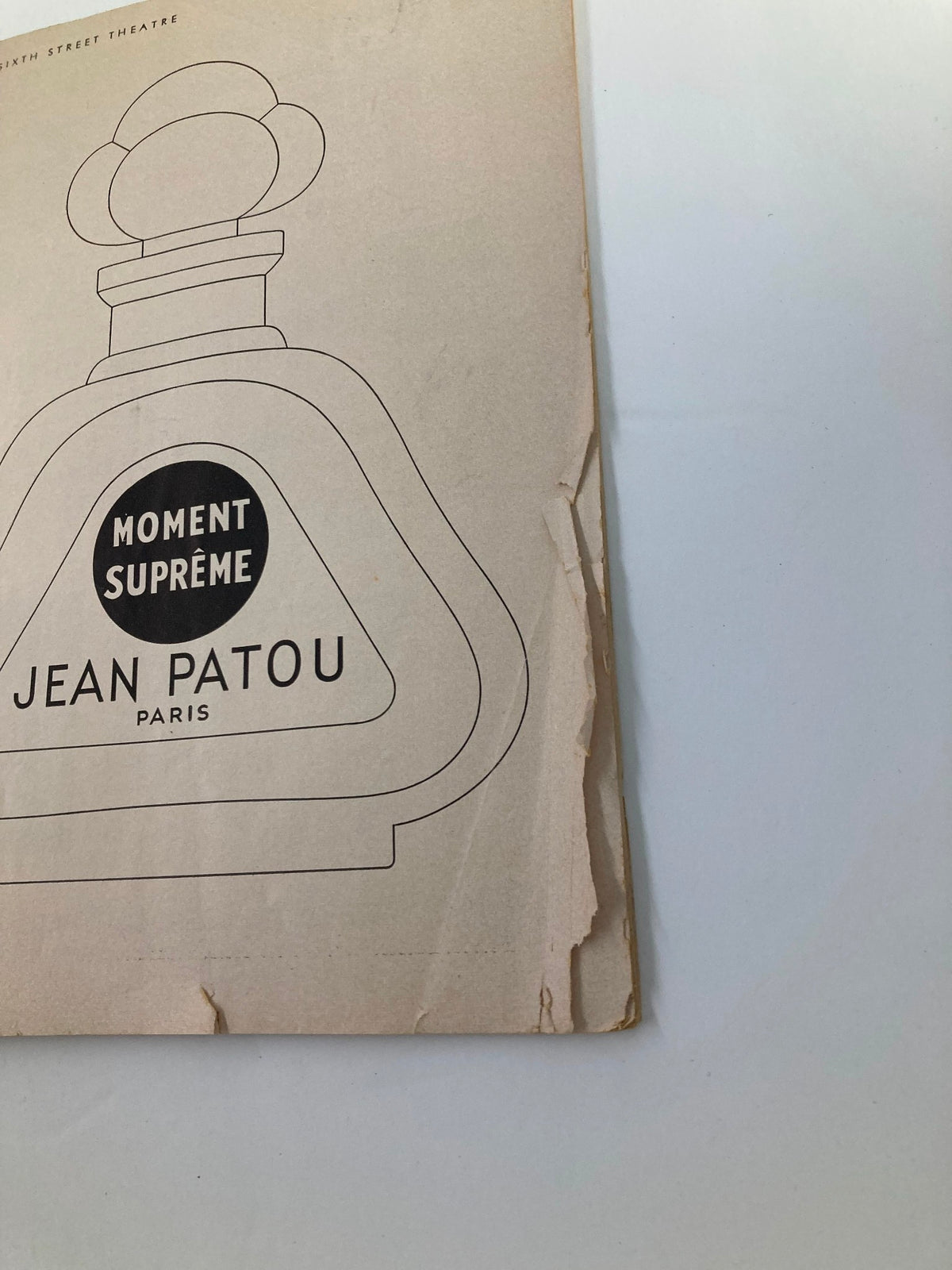 Back cover of the 1954 Playbill for the Forty-Sixth Street Theatre showcasing an advertisement for Jean Patou perfume titled 'Moment Suprême'.