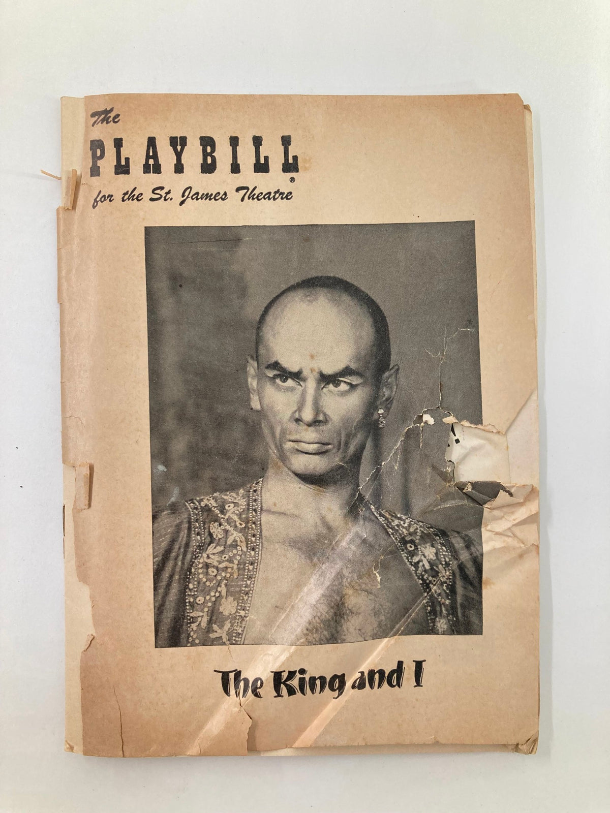 1953 Playbill from the St. James Theatre featuring Yul Brynner in The King and I. The vintage playbill shows signs of aging with creases and wear, capturing the essence of Broadway's golden age.
