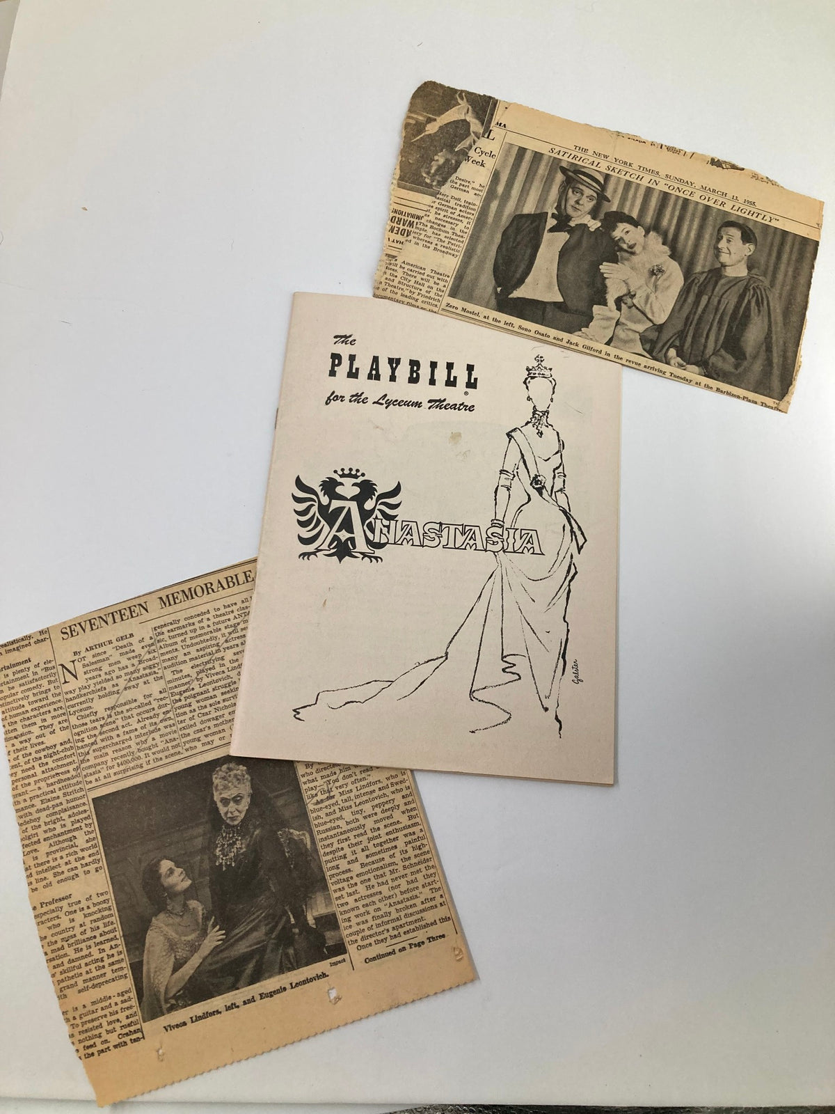 Vintage 1955 Playbill for the Lyceum Theatre featuring Eugenie Leontovich and Viveca Lindfors in Anastasia, surrounded by various newspaper clippings related to the production.