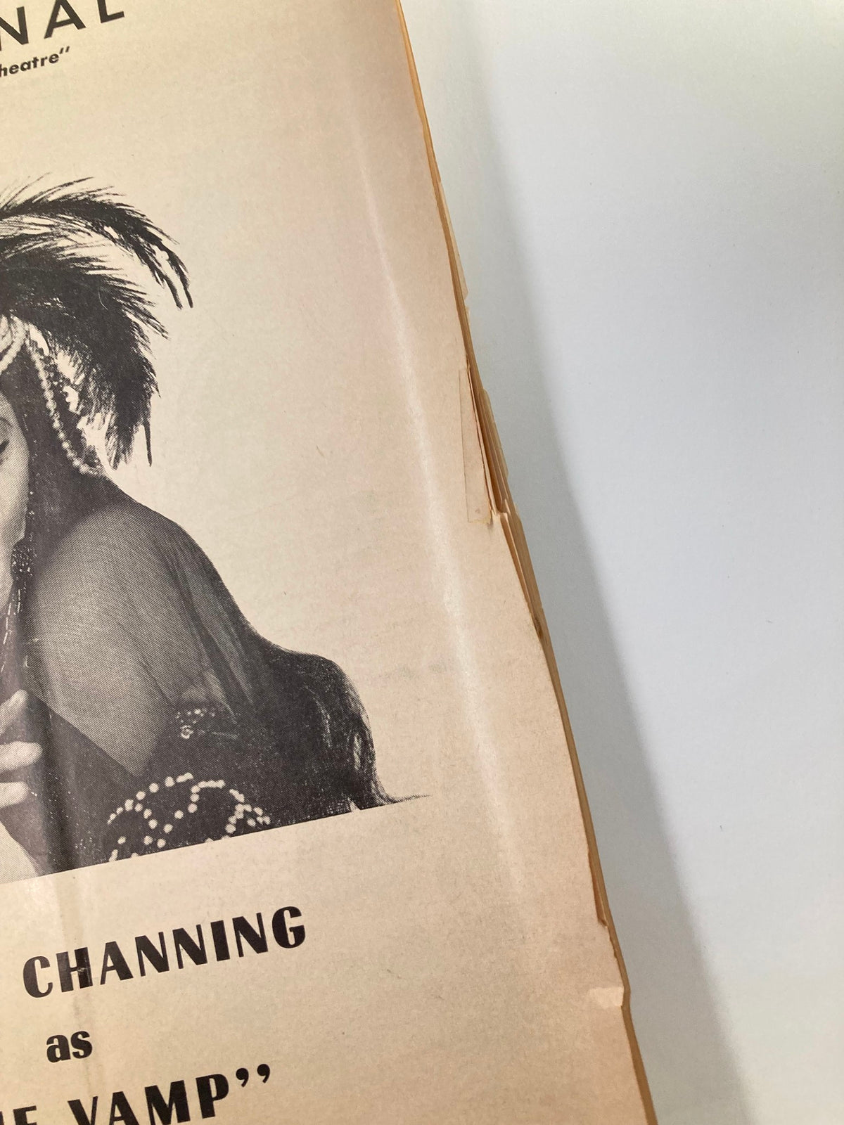 Close-up view of the edge of the 1955 Souvenir Program from the National Theatre, highlighting minor wear and the title 'The Vamp' featuring Carol Channing.