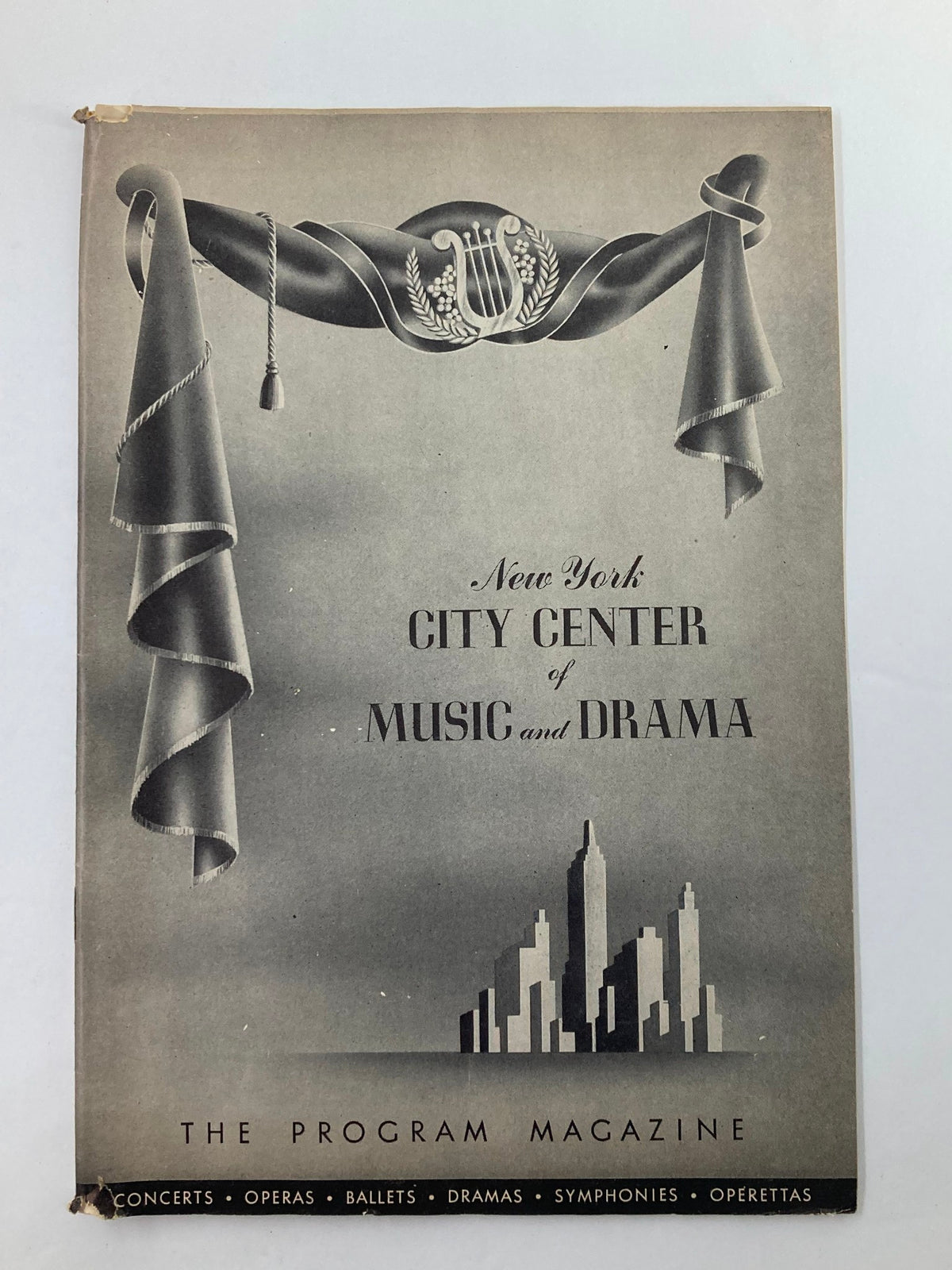 Cover of 1948 Program Magazine New York City Center featuring artistic graphics of a stage with a curtain and city skyline.