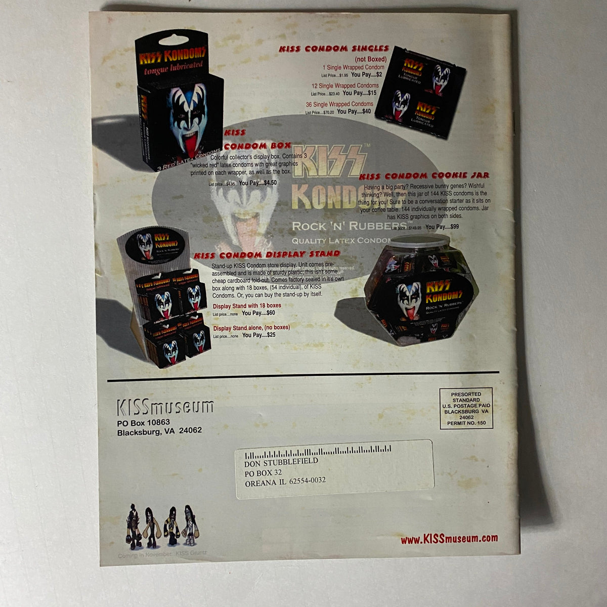 Back cover of the KISS Museum.com Catalog Fall 2002 displaying KISS Kondom products, including display stands and condom boxes themed around the iconic rock band.