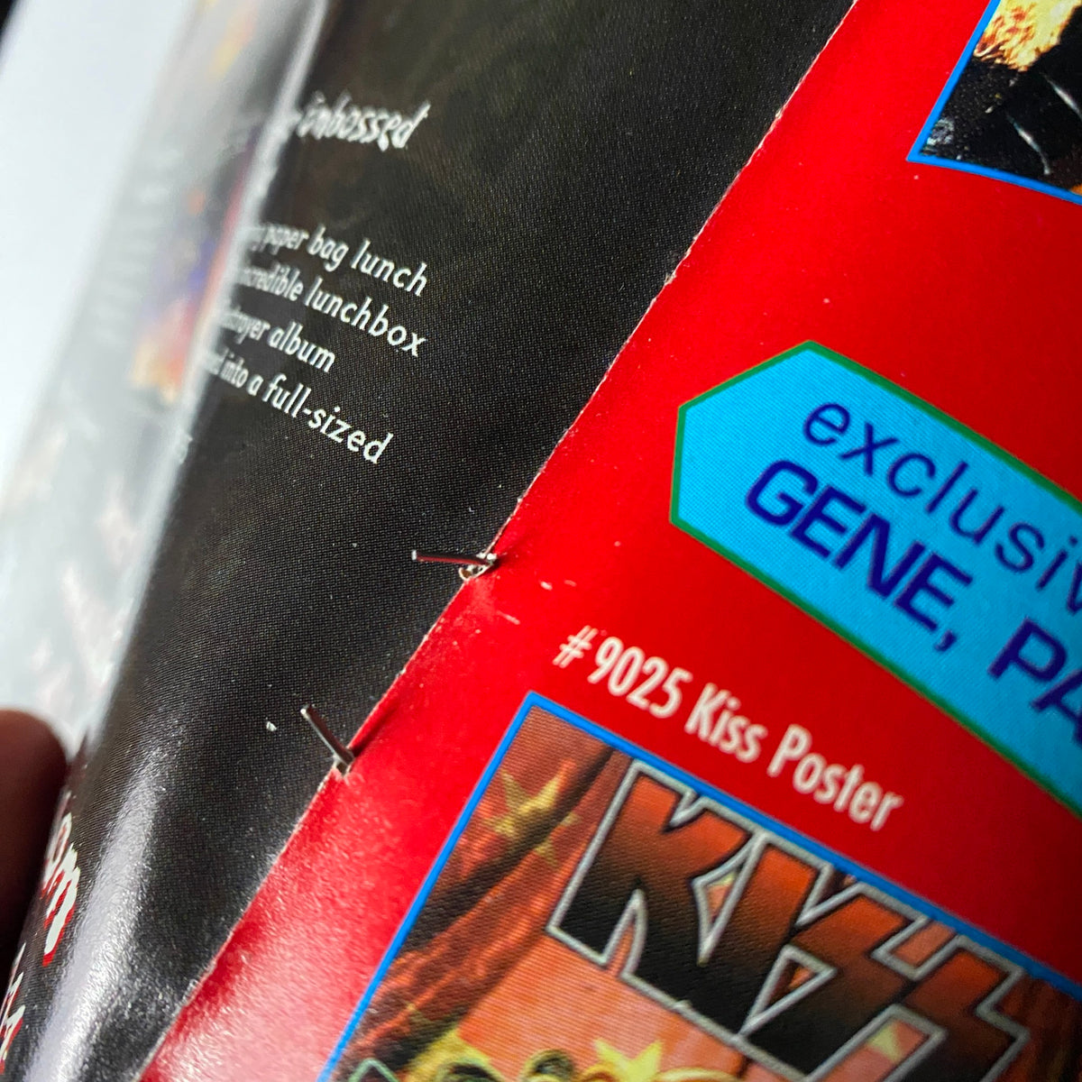 Close-up of the binding of KISS Farewell Poster Book: Metal Edge Special 2000, highlighting exclusive Gene Simmons content.