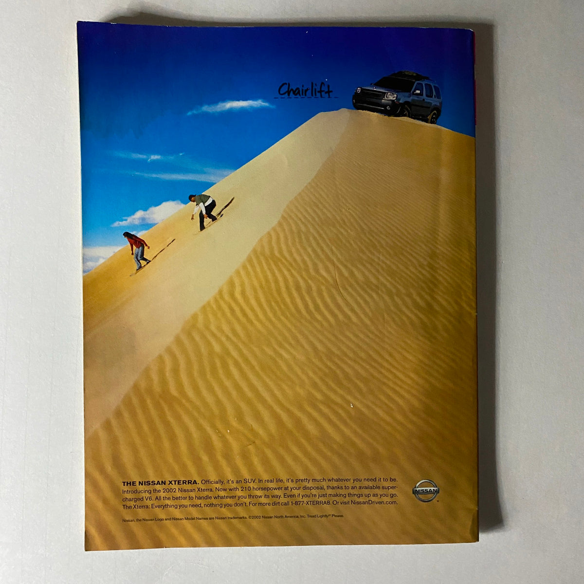 Back cover of Spin Magazine September 2002 featuring a striking advertisement for the Nissan Xterra, showcasing off-road adventure on a sand dune. The tagline 'Chairlift' adds an intriguing element, emphasizing the spirit of exploration in the metal era.