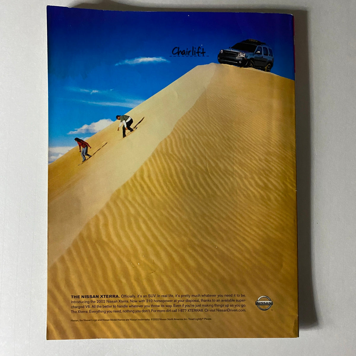 Another view of the back cover of Spin Magazine September 2002 with the Nissan Xterra advertisement, illustrating the adventurous lifestyle synonymous with the era's music scene. The phrase 'Chairlift' suggests a thrilling outdoor experience.